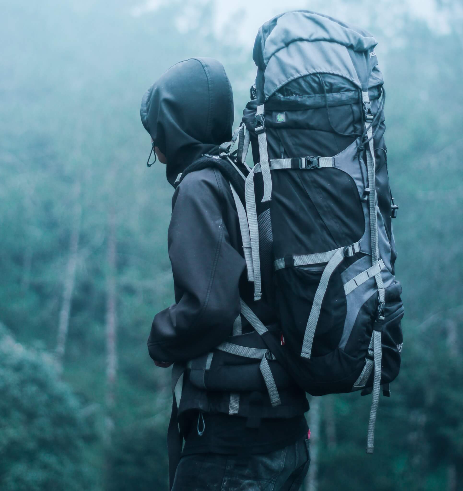 A man with a large backpack hiking. 