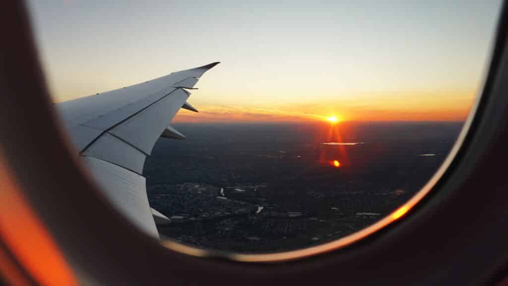 Looking out of an airplane window at the sunset