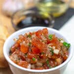 We love this easy homemade tomato bruschetta recipe. It's filled with tomatoes, onions, garlic, basil, and other delicious additions. Serve bruschetta on crostini for the perfect appetizer! #gayglobetrotter #bruschetta #tomato #tomatobruschetta #homemadebruschetta #bestbruschetta #bruschettarecipe #easybruschetta