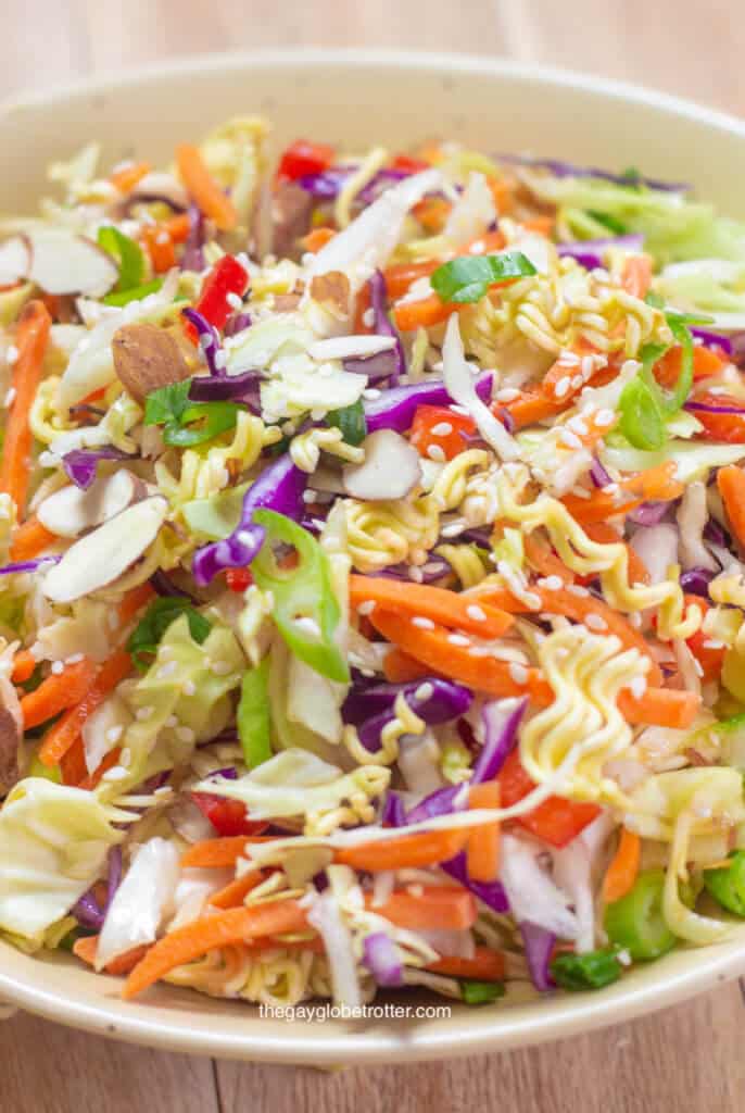 A bowl full of ramen noodle salad with Asian sesame dressing.