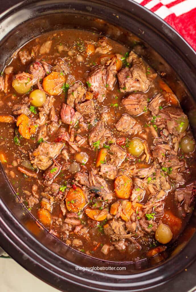 An overhead shot of beef bourguignon in a slow cooker ready to serve.