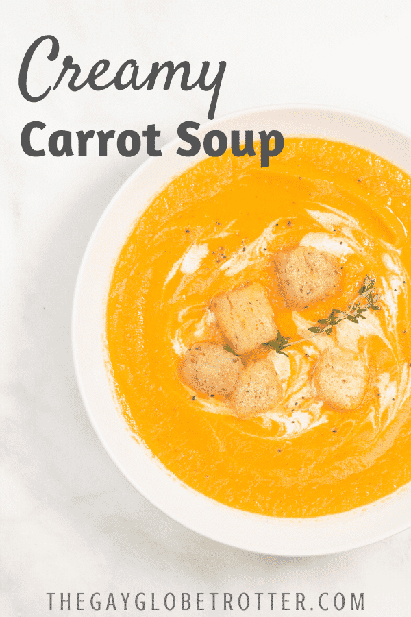 A bowl of creamy carrot soup with text overlay that reads "creamy carrot soup"