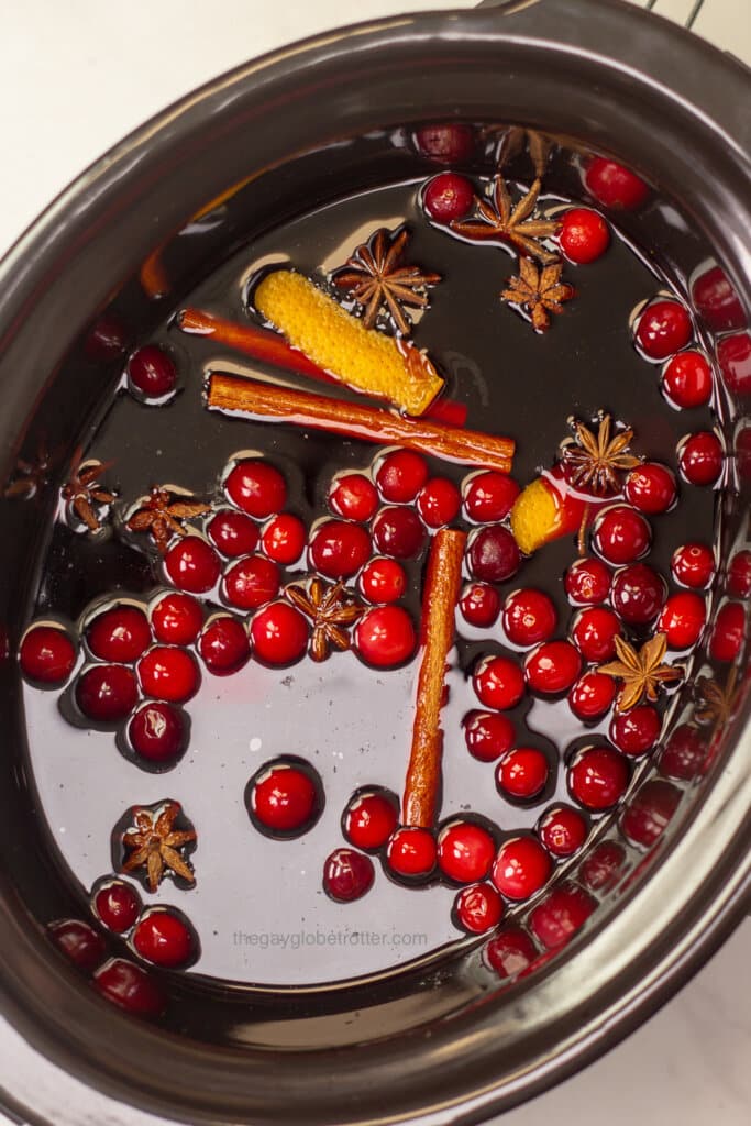 A slow cooker full of wine and mulling spices.