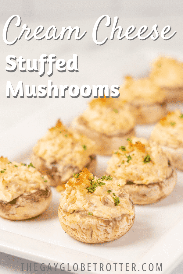 Cream cheese stuffed mushrooms on a plate with text overlay that says "cream cheese stuffed mushrooms"