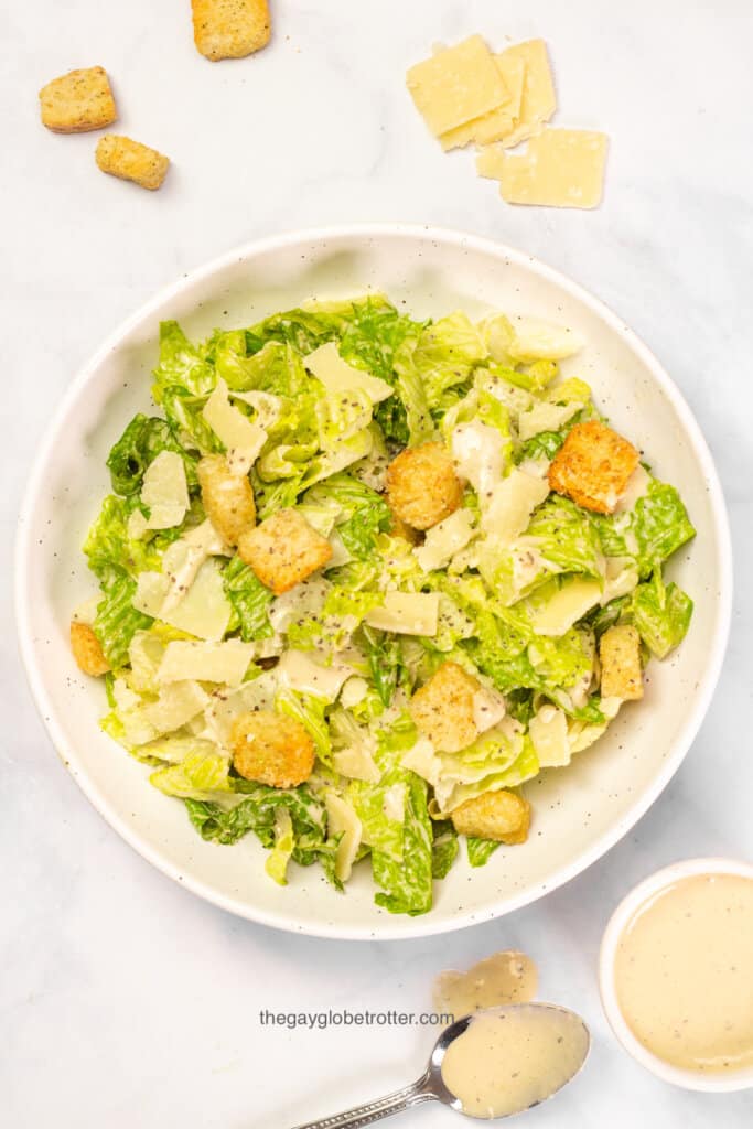 A big bowl of caesar salad topped with croutons.