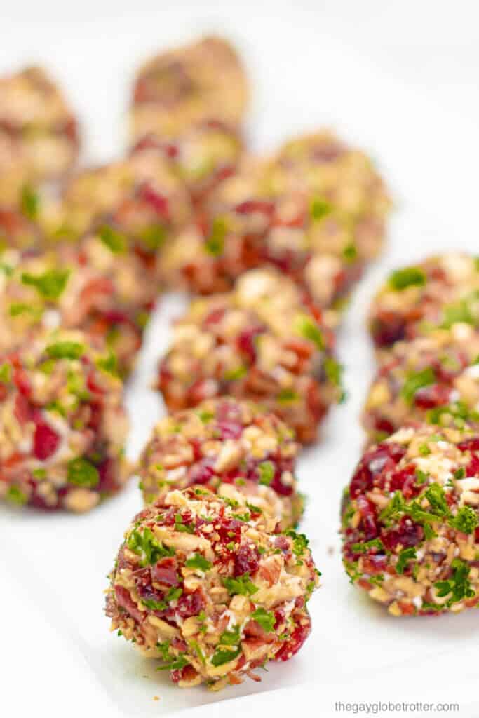 A serving platter full of cranberry pecan cheese ball bites.