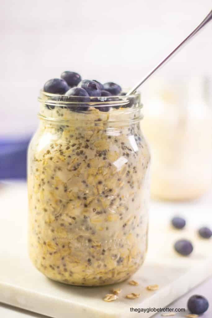 A jar of blueberry overnight oats ready to eat. 