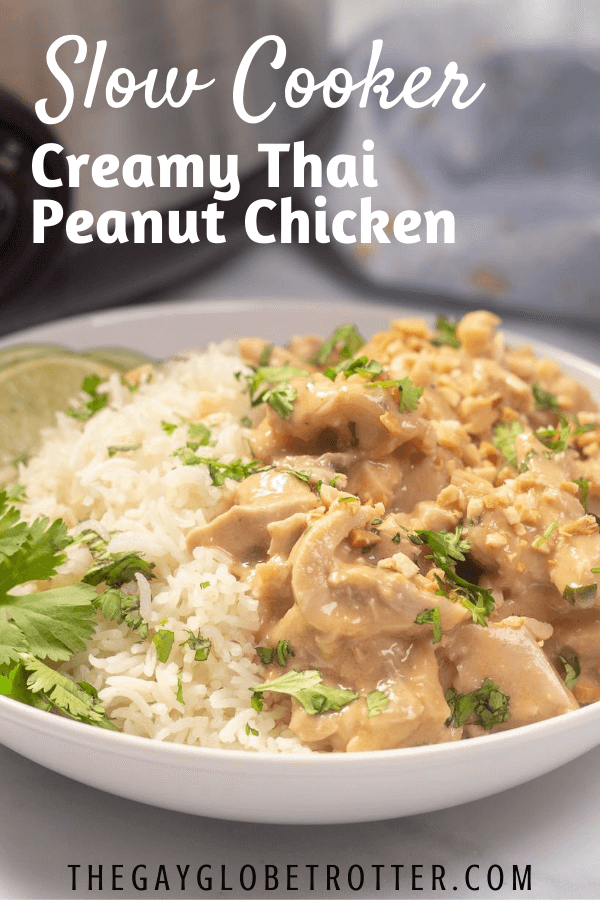 A bowl of thai peanut chicken with text overlay that says "slow cooker thai peanut chicken"