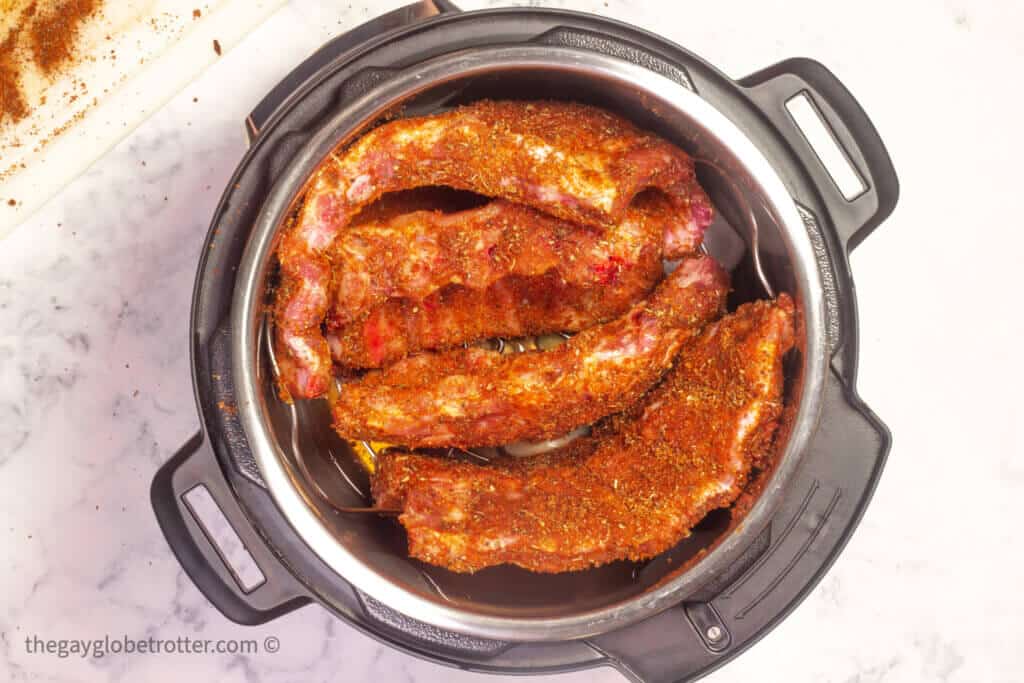 Ribs sitting on a rack in an Instant Pot.