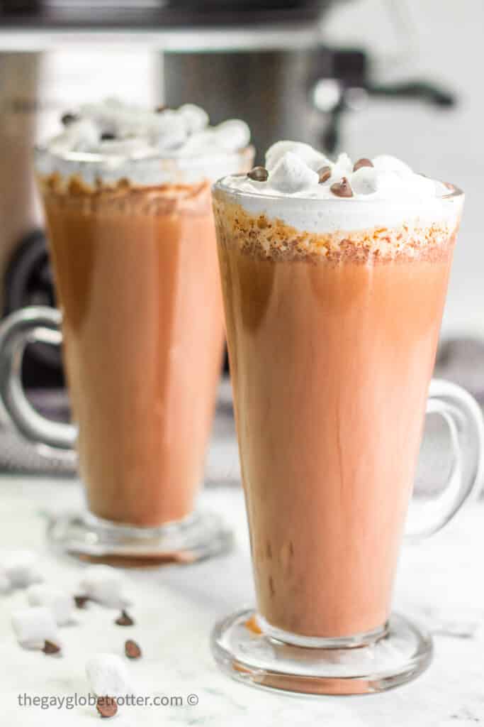 A cup of CrockPot hot chocolate with mini marshmallows and chocolate chips.