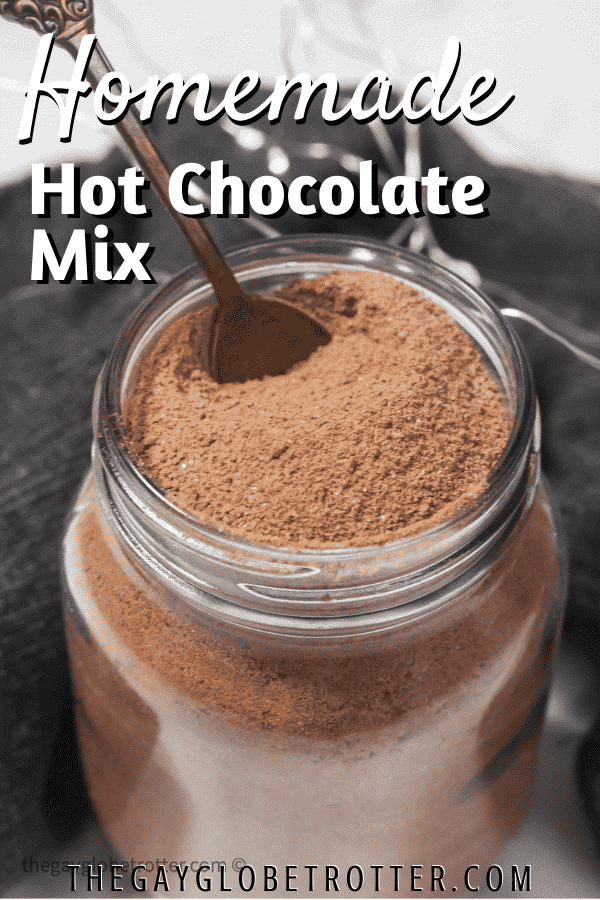 A spoon in a glass jar of homemade hot chocolate mix.