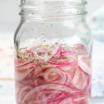 Quick pickled red onions in a mason jar.