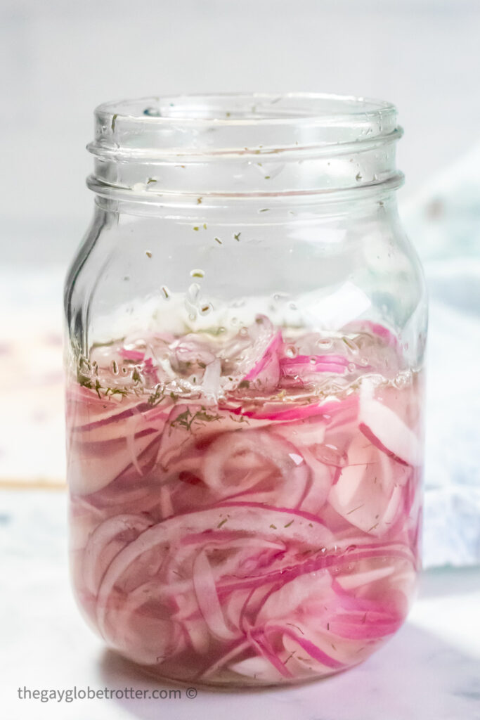 Quick pickled red onions in a mason jar.