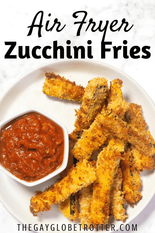 Air fryer zucchini fries next to marinara sauce with text overlay.
