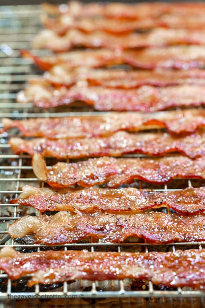 Candied bacon cooling on a wire rack.