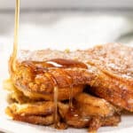 Syrup being drizzled over creme brulee french toast.