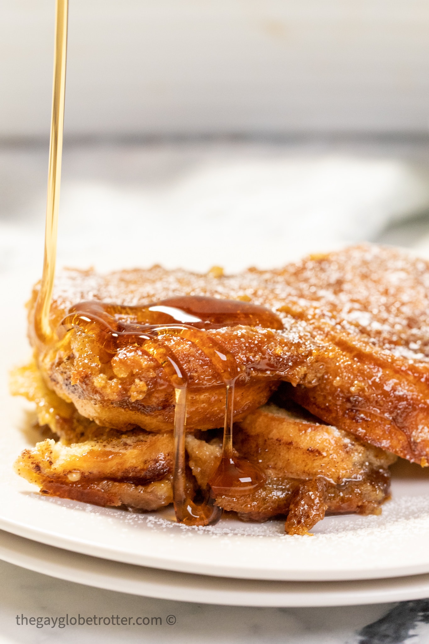 Syrup being drizzled over creme brulee french toast.