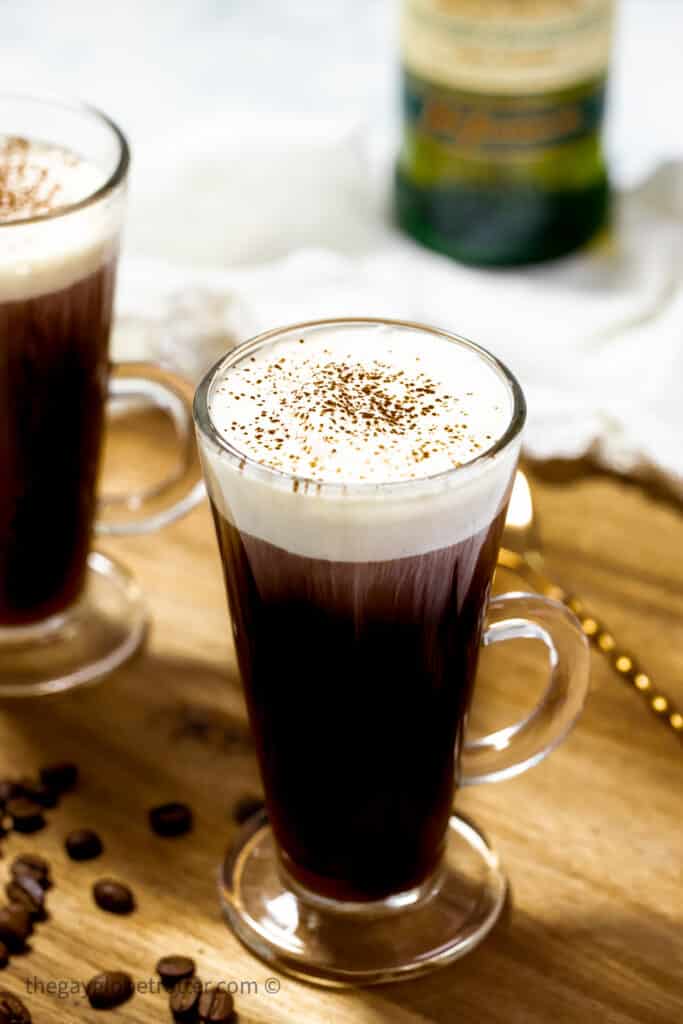 2 cups of Irish coffee next to a stirring spoon.