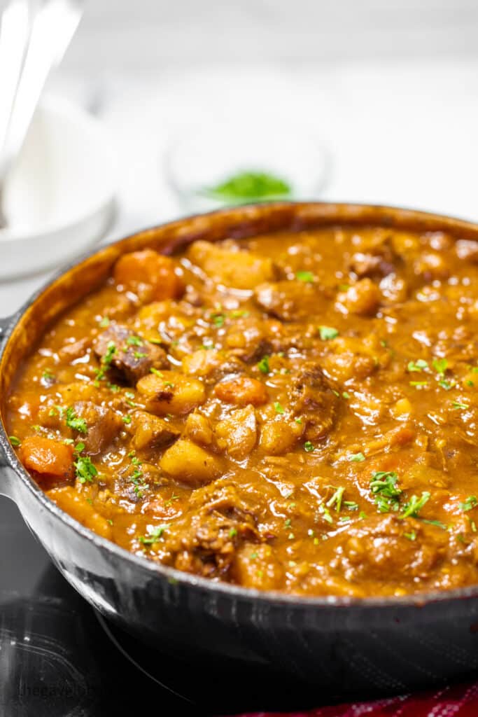 A pot of Guinness stew topped with parsley.