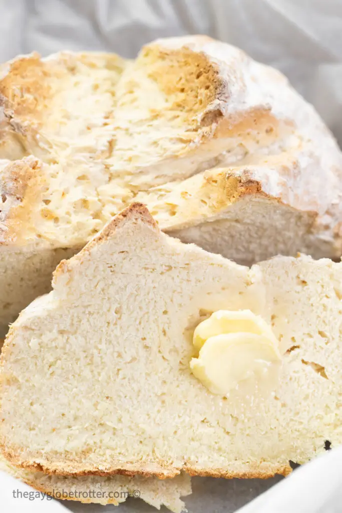 A slice of Irish soda bread with butter on it.