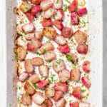 Roasted radishes in a baking dish garnished with parsley.