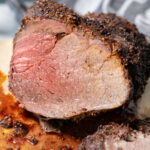 Air fryer roast beef on a cutting board.