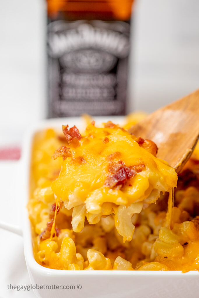 A spoon serving bacon bourbon mac and cheese.