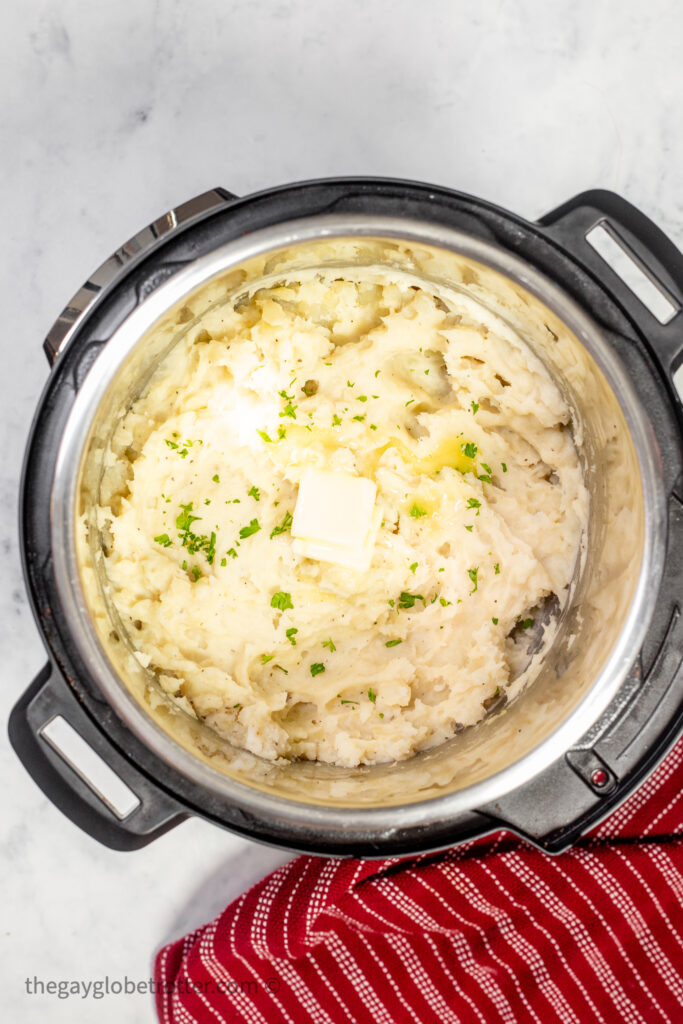 Instant Pot garlic mashed potatoes topped with butter. potatoes