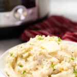 A serving bowl of Instant Pot garlic mashed potatoes.