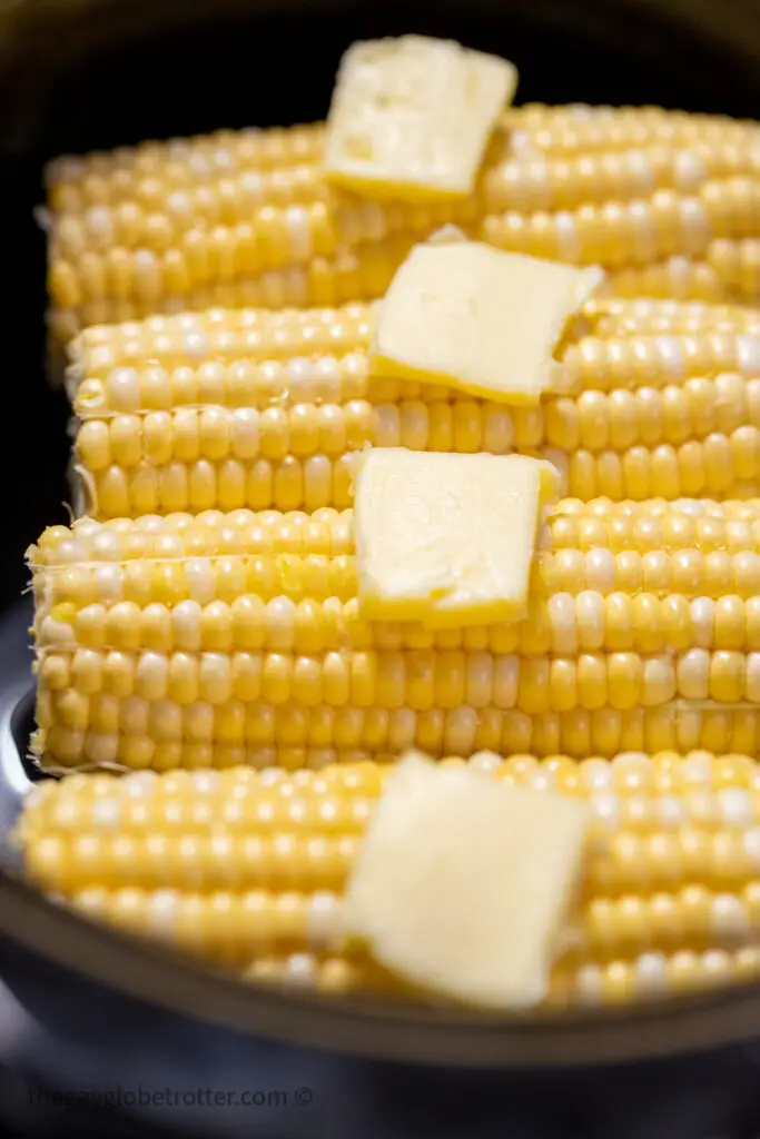 Butter on raw corn on the cob in a CrockPot.