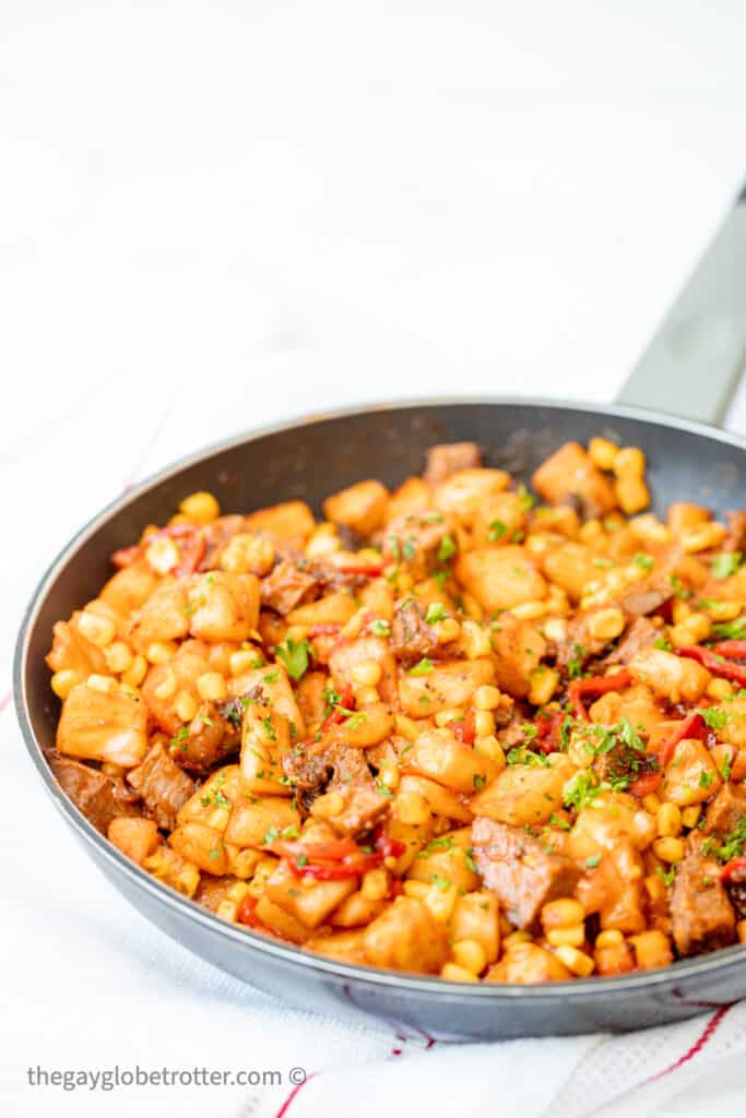 Roast beef hash in a frying pan.