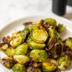 A serving plate of air fried brussels sprouts.
