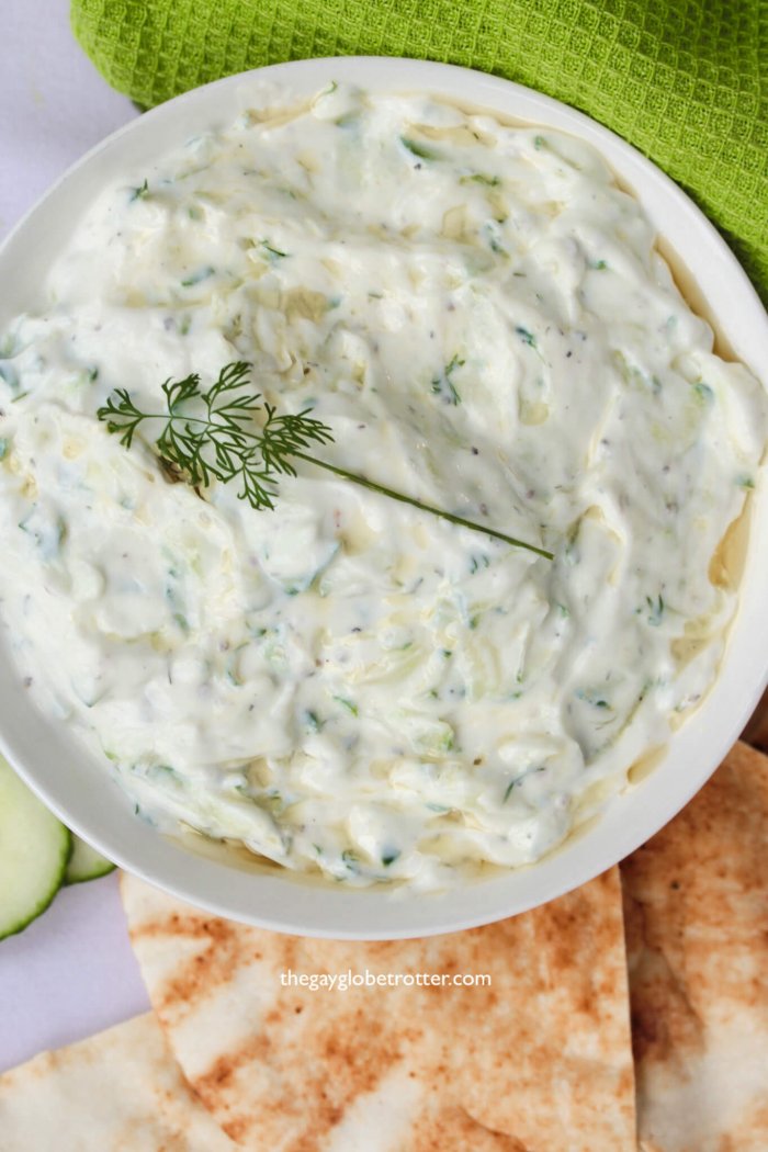 A bowl of fresh homemade tzatziki topped with dill.
