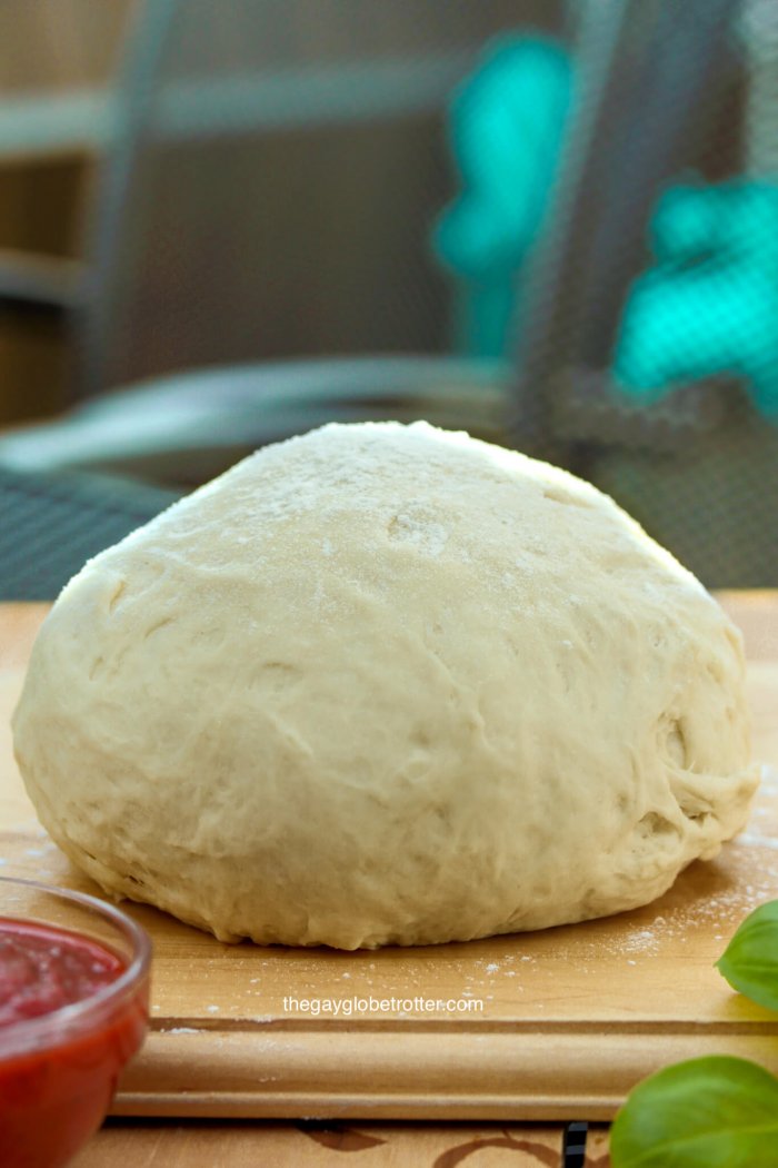 Italian Pizza Dough on a work surface with flour.