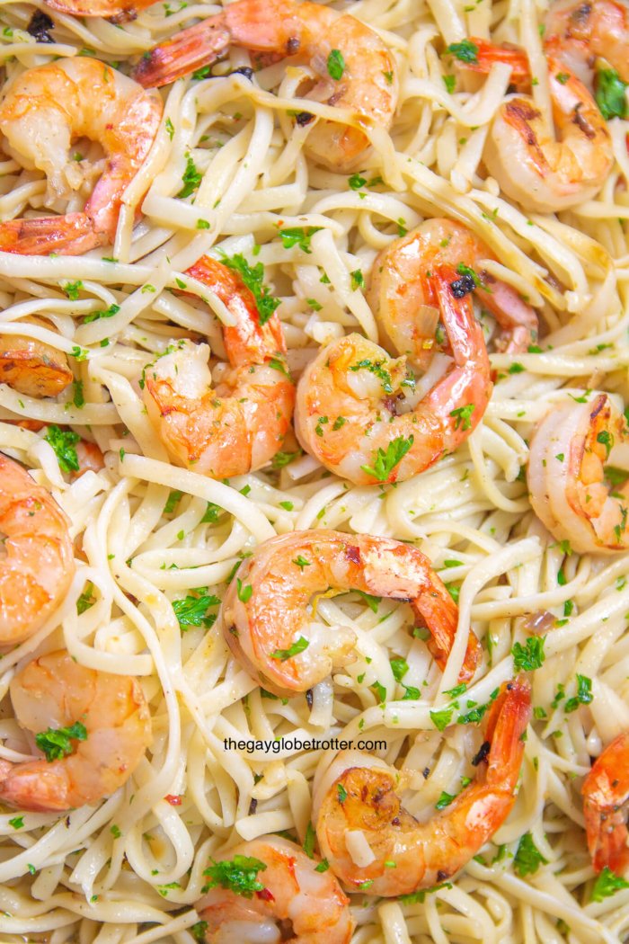 A close up of shrimp scampi with linguine noodles.